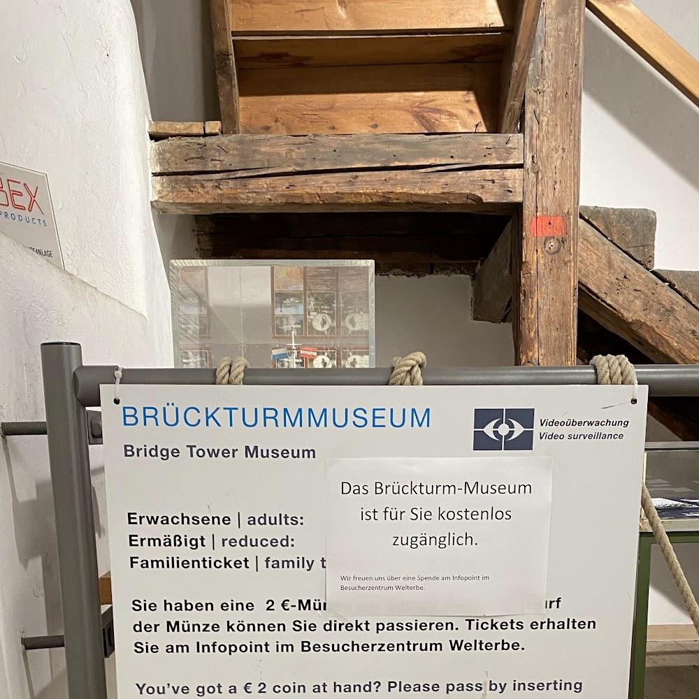 Bridge Tower Museum, sign with a wooden beam and a photo.